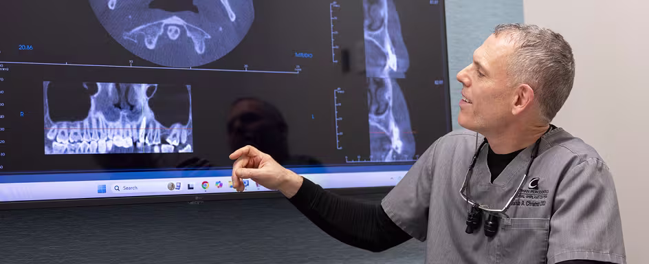 Dr. Christman reviewing digital X-rays to plan a dental implant procedure in his Lancaster office
