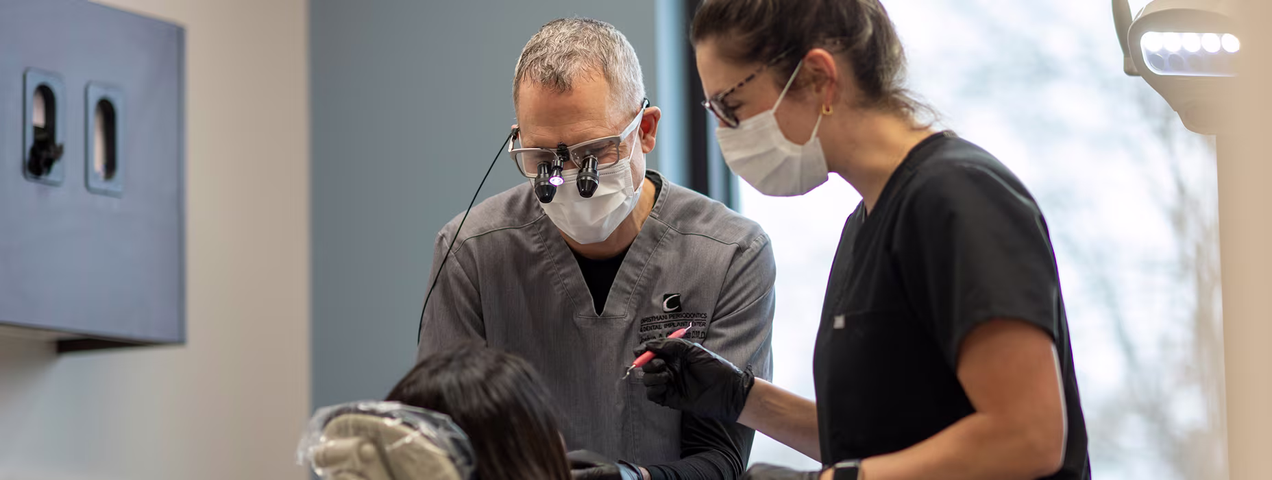 Dr. Christman performing a dental implant procedure using advanced surgical techniques at Christman Periodontics