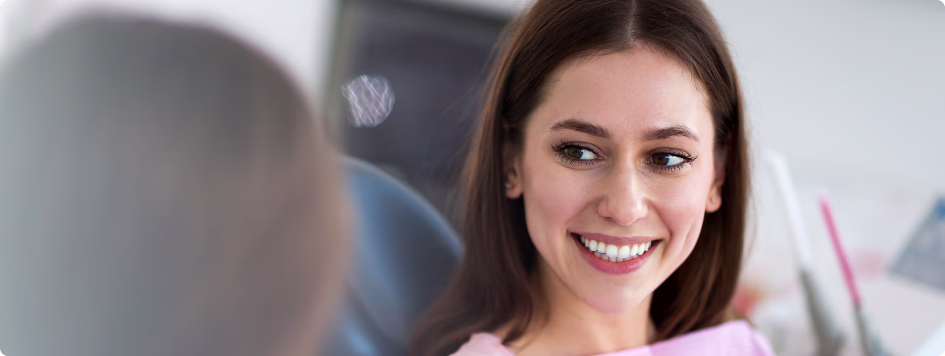 A happy patient in the dental exam chair after a successful dental implant consultation in Lancaster, PA